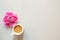 Cup of coffee and fresh beautiful spring pink peony flower on light background, top view, flat layout, copy space