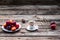 Cup of coffee and fresh plums on wood, free space