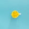 cup of coffee full of sunny yellow spring dandelion.flowery concept in a blue flat lay concept