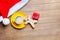 Cup of coffee, gift, gingerbread man and santa claus hat on the
