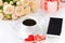 Cup of coffee gingerbread hearts , lot of roses and a phone on a background of white organza. Valentine`s day .The day of the wedd