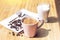 Cup of coffee and glass of almond milk on wooden table, close up