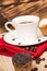 Cup of coffee and a handful of homemade biscotti with chocolate and almonds on a wooden table