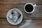 Cup of coffee with handmade chocolate cake on wooden table background. Brownie with cherries on a white plate.