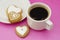 Cup of coffee and heart shaped cookies, biscuits. Valentine heart cookies. Top view. Pink background