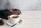 Cup of coffee , homemade cake and pine cones on white wooden tab