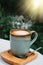 Cup of coffee latte in green poetry mug on old wooden background in the morning sunlight