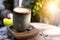 Cup of coffee latte in green poetry mug on old wooden background in the morning sunlight