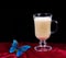 Cup of coffee latte on red silk and blue morpho batterfly. copy spaces