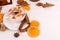 Cup of coffee with marshmallows and cocoa, leaves, dried oranges, spices, on a white background. Delicious hot autumn drink,