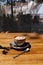 A cup of coffee with marshmallows on a wooden table background. A cocoa drink in a porcelain cup with a metal spoon.