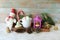Cup of coffee with meringue and dessert, Christmas decor, snowman, lantern with a burning candle, on a wooden table, the concept o