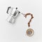 A cup of coffee, metal coffee maker and coffee beans in the shape of a question mark on a gray background with space for