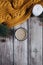 Cup of coffee with milk, candle, bumps, spruce branches and warm orange scarf on wooden table