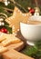 Cup of coffee with milk and christmas sugar cookies