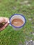 A Cup of Coffee Milk in Dreamy Green Garden