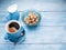 Cup of coffee, milk jug and cane sugar cubes.