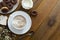 Cup of coffee,milk saucer and donuts, on wooden table with copy space