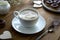 Cup of coffee,milk saucer and donuts, on wooden table with copy space