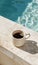 Cup of Coffee Next to Pool Ledge