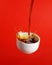 Cup of coffee over red background. Food levitation