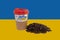 Cup of coffee with a patriotic sticker and a handful of roasted coffee beans against the background of the flag of Ukraine