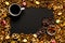 Cup of coffee among pile of various cookies, almonds and multicolored caramelon,black chocolate with nuts, black wooden background