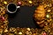 Cup of coffee among pile of various cookies, croissant, multicolored caramelon, black chocolate with nuts black wooden background