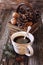 Cup of coffee, pine cones in basket, walnuts and cinnamon sticks