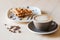 Cup of coffee and plate of belgian waffles on light wooden table