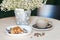 Cup of coffee and plate of belgian waffles on light wooden table in cafe