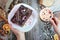 Cup of coffee and a plate of cake Sacher in female hands