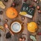 Cup of coffee, pumpkins, leaves, chestnuts, wild apples, board inscription Fall. Flat lay. Concept of autumn