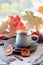 Cup of coffee, pumpkins, leaves, spices, a scarf on a wooden surface on a window background