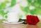 Cup of coffee with a red rose