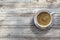 Cup of coffee on a rustic damaged wooden table. Mockup and empty copy space.