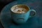 a cup of coffee with a sad face drawn on it
