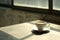 cup of coffee sits on a table bathed in the gentle morning sunlight