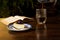 Cup of coffee and slice of cheesescake with open book on wooden table.