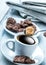Cup of coffee spoon with cane sugar, chocolate biscuits and the background newspaper.