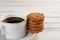 Cup of coffee & stack of sweet cookies on white background