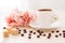 Cup of coffee standing on the table with coffee beans scattered around and pieces of  cane sugar ,