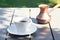 A cup of coffee stands on a wooden table in the garden.