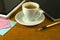 cup of coffee, stationery, keyboard and tablet on the table closeup