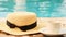 cup of coffee and a straw hat on the background of a swimming pool on a summer sunny day. Good morning concept and