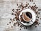 Cup of coffee surrounded by coffee beans. Top view.