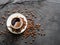 Cup of coffee surrounded by coffee beans. Top view.