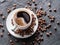 Cup of coffee surrounded by coffee beans. Top view.