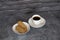 Cup of coffee on the table with biscuits cookies black bricks background