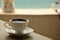 A Cup of coffee on the table in a cafe on the beach.